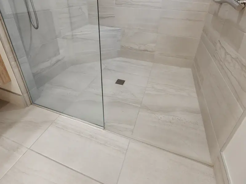 Douche à l’italienne carrelée en grand format avec paroi vitrée